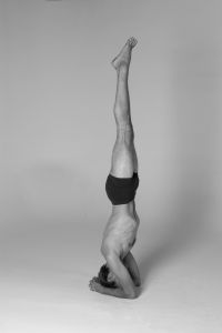 A Men In One Of The Very Famous Aasans - HeadStand